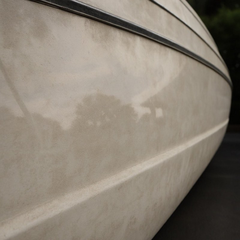 Chalky, oxidized, faded gelcoat on a boat hull before restoration